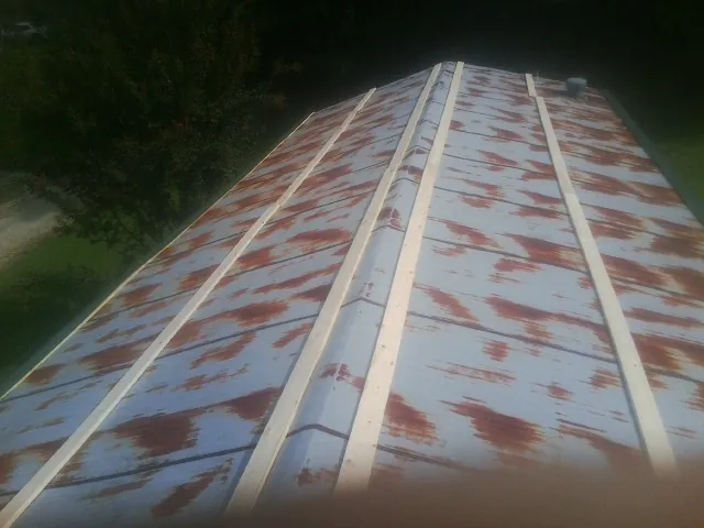 Rusted metal roof panels with new wood purlins before replacement — Storm Damage Roof Repair in Vernon by Roofing Brothers